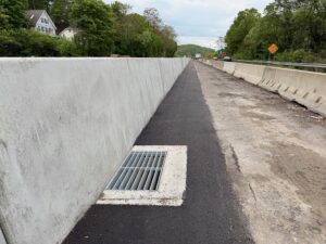 New drainage catch basin along new concrete barrier