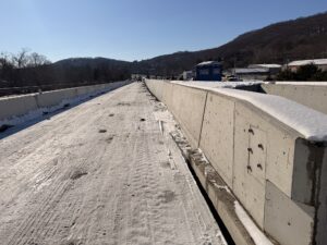 The work zone on Route 8 covered in a dusting of snow between the median and temporary concrete barrier