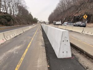 Permanent concrete median barrier placed in the median flanked by temporary barrier to create a work zone on Route 8