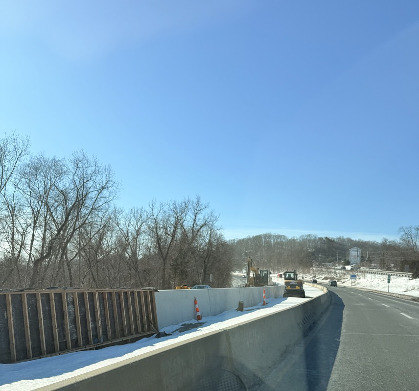 Route 8 with snow on the grass area and within the work zone