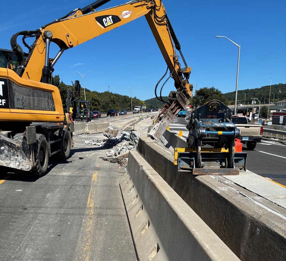 Hoe ramming existing median barrier